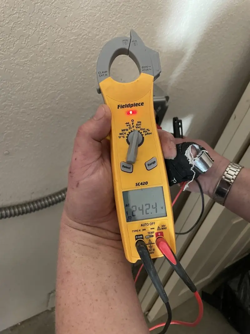 Voltage testing with clamp meter during Whole House Surge Protector in Caldwell